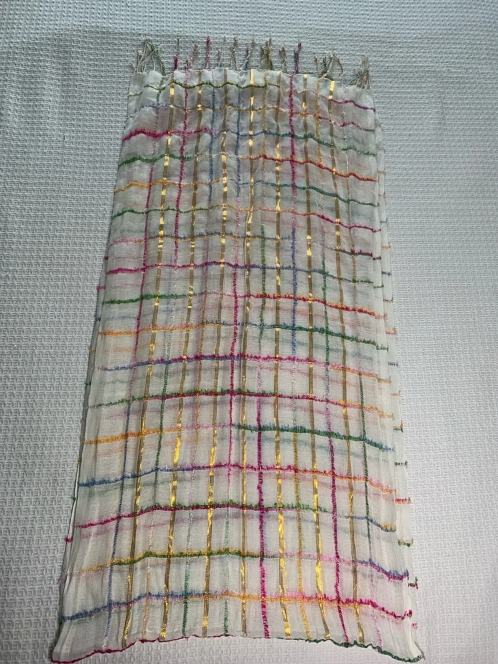 White, metallic gold, pink, blue, and green scarf with fringe